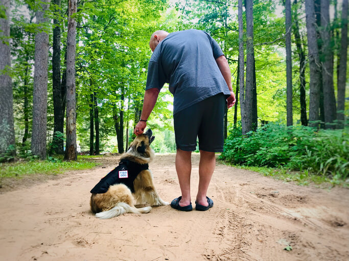 Mental Health Service dog and owner working together outdoors.